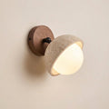 Adjustable circular travertine wall light with frosted glass diffuser and round wood base
