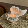 Celestial angel wings resin candle holder with intricate feathered detail and ethereal glow