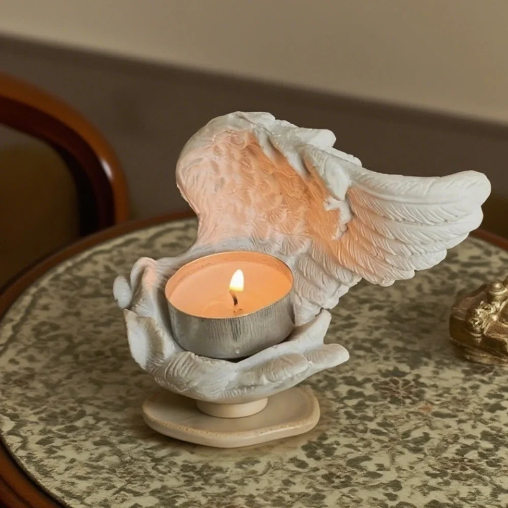 Celestial angel wings resin candle holder with intricate feathered detail and ethereal glow