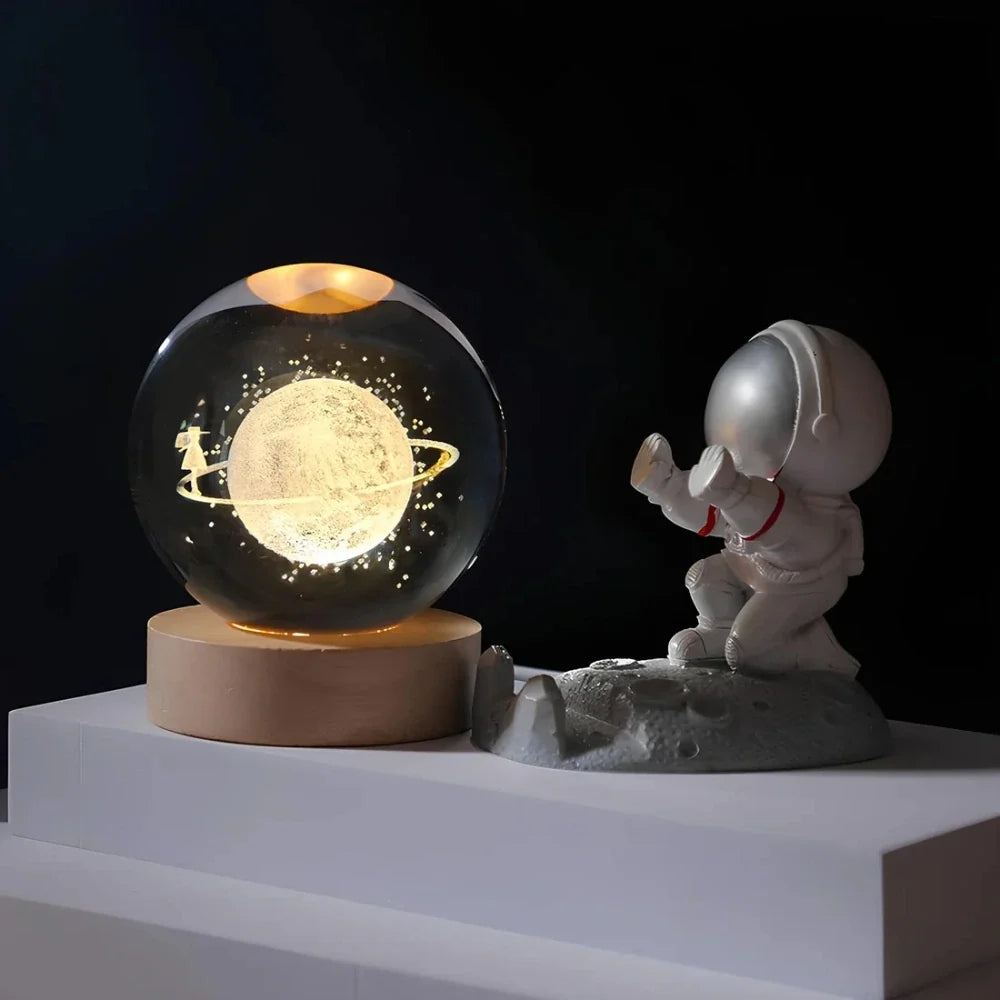 Luminous crystal ball with 3D engraved planets and space scenes, warm white LED glow 10
