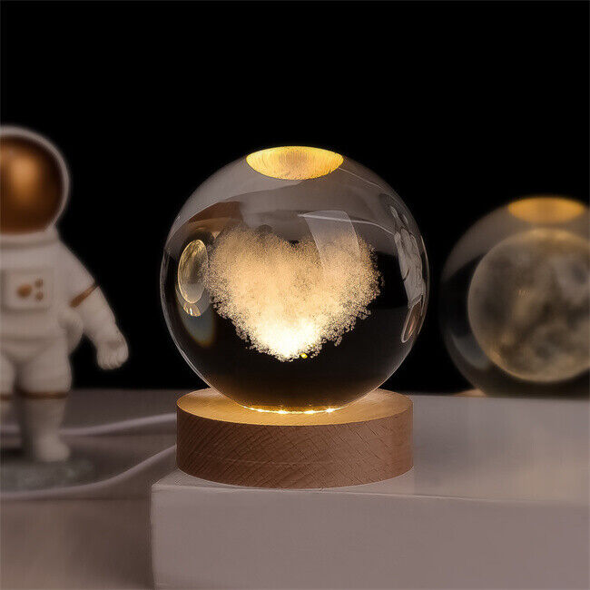 Luminous crystal ball with 3D engraved planets and space scenes, warm white LED glow 12