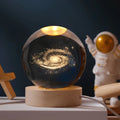 Luminous crystal ball with 3D engraved planets and space scenes, warm white LED glow 2