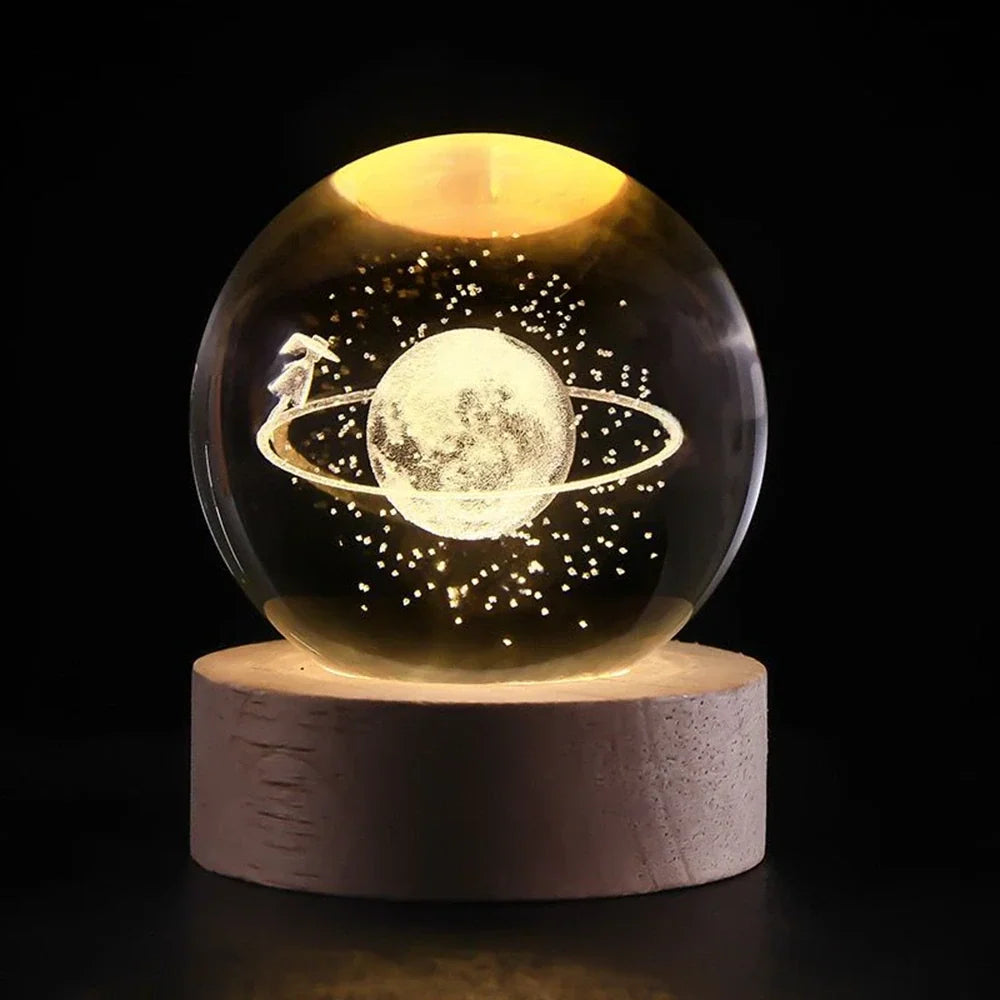 Luminous crystal ball with 3D engraved planets and space scenes, warm white LED glow 27