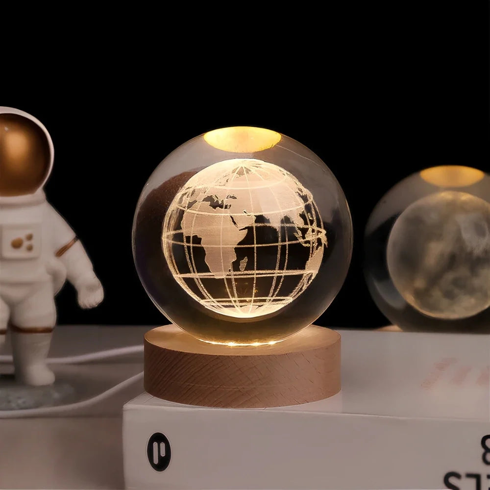 Luminous crystal ball with 3D engraved planets and space scenes, warm white LED glow 9