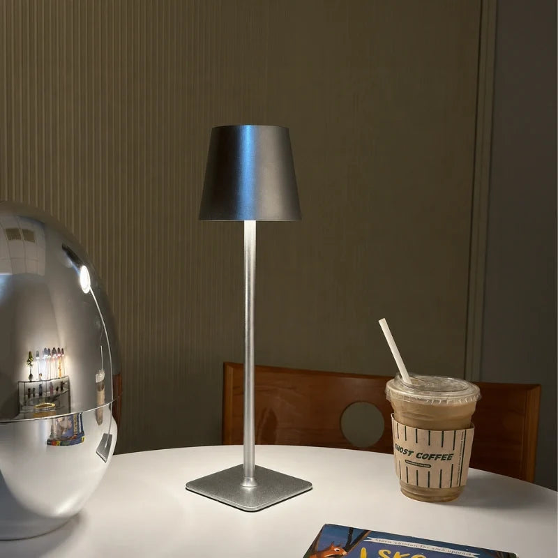 Cordless dimmable tall table lamp with sleek metal stem and warm LED light. 22