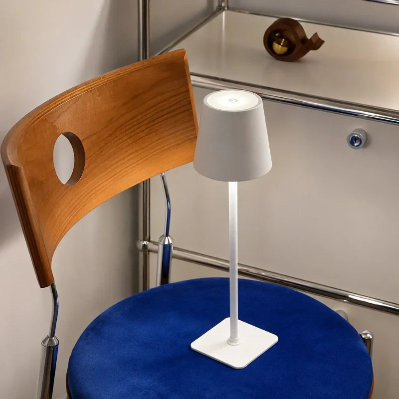 Cordless dimmable tall table lamp with sleek metal stem and warm LED light. 33