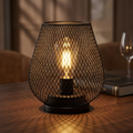 Cordless metal cage table lamp with warm light for indoor and outdoor use.