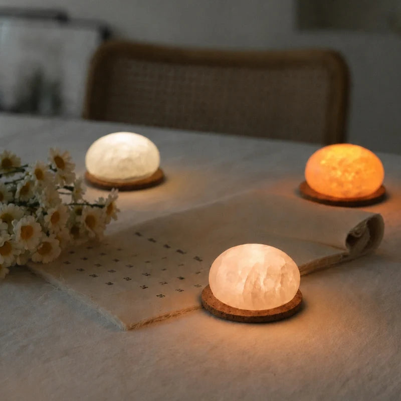 Handcrafted cordless mineral glow lamp with warm ambient light on a table