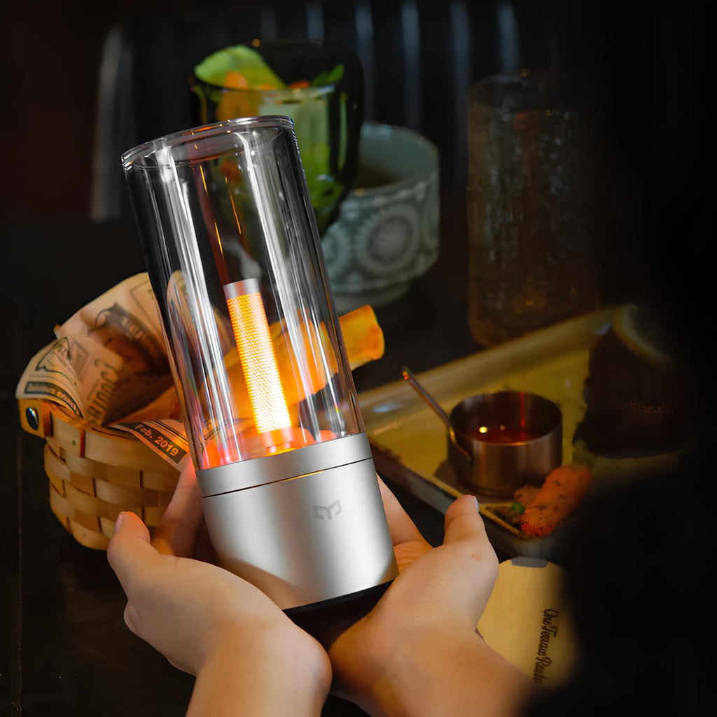 Dimmable cylindrical table lamp with clear glass body and warm white light glow