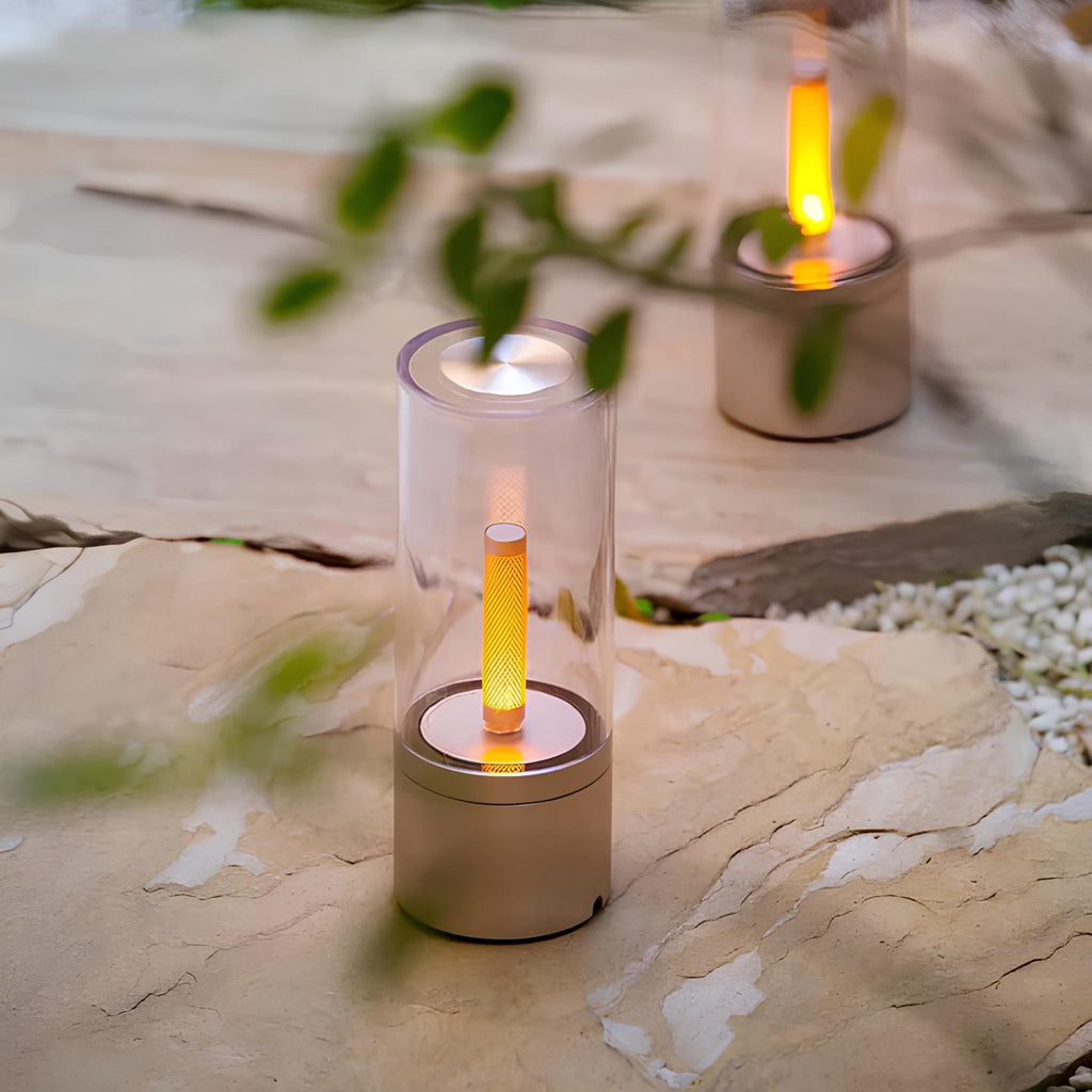 Dimmable cylindrical table lamp with clear glass body and warm white light glow 2
