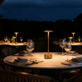 Dimmable Luxora table lamp with sleek disc head and cylindrical aluminium base, modern minimalist design