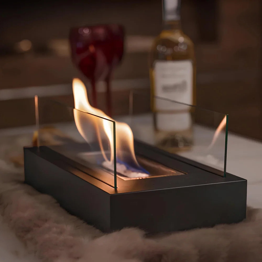 Elegant tabletop fireplace with tempered glass panels and metal base showcasing real flame ambiance