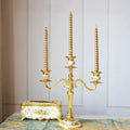 Gilded Nocturne vintage candelabra with adjustable arms and floral detailing in gold alloy