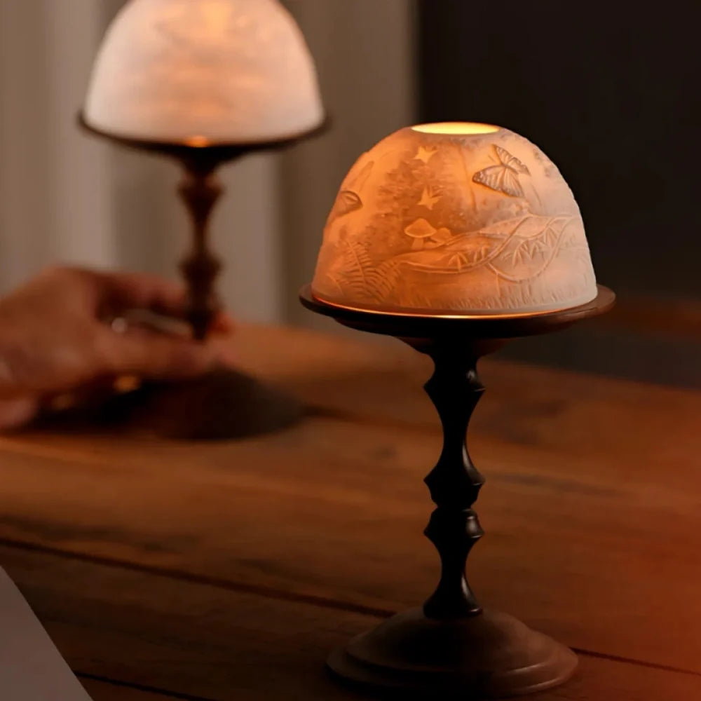 Hand-carved porcelain WhisperDome candle holder with walnut wood base, featuring nature relief design and warm candlelig