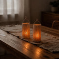 Handwoven natural fiber lantern with warm white flickering light and handle for display