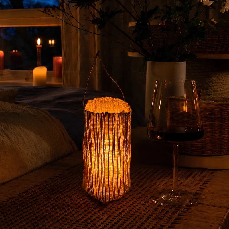 Handwoven natural fiber lantern with warm white flickering light and handle for display 3