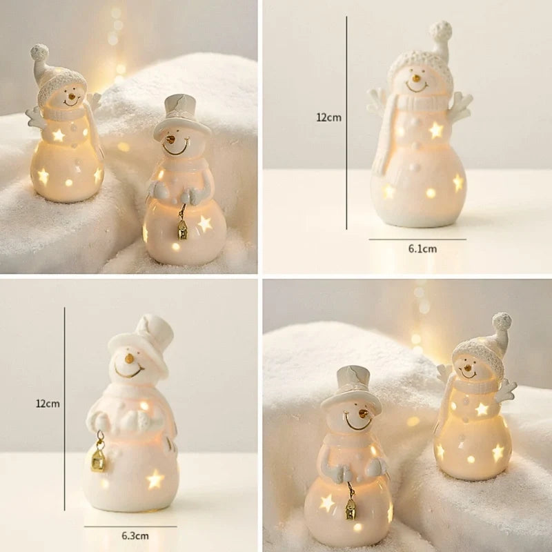 Illuminated ceramic village set with white houses, snowmen, and fir trees with warm glowing windows 14