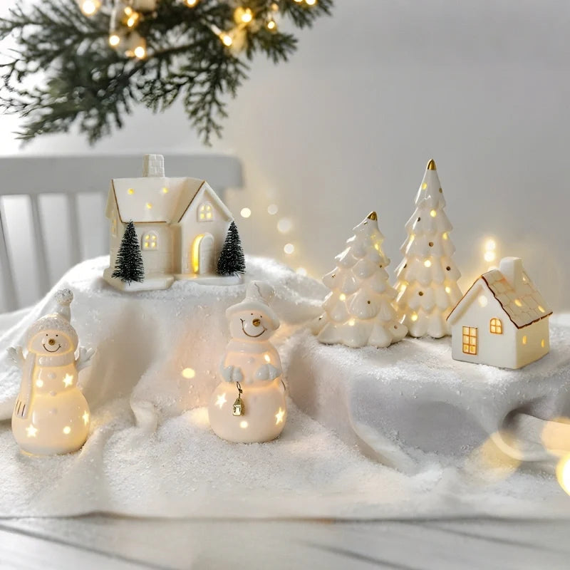 Illuminated ceramic village set with white houses, snowmen, and fir trees with warm glowing windows 5