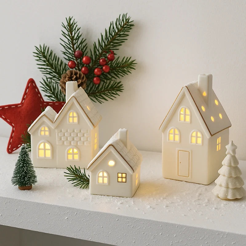 Illuminated ceramic village set with white houses, snowmen, and fir trees with warm glowing windows 7