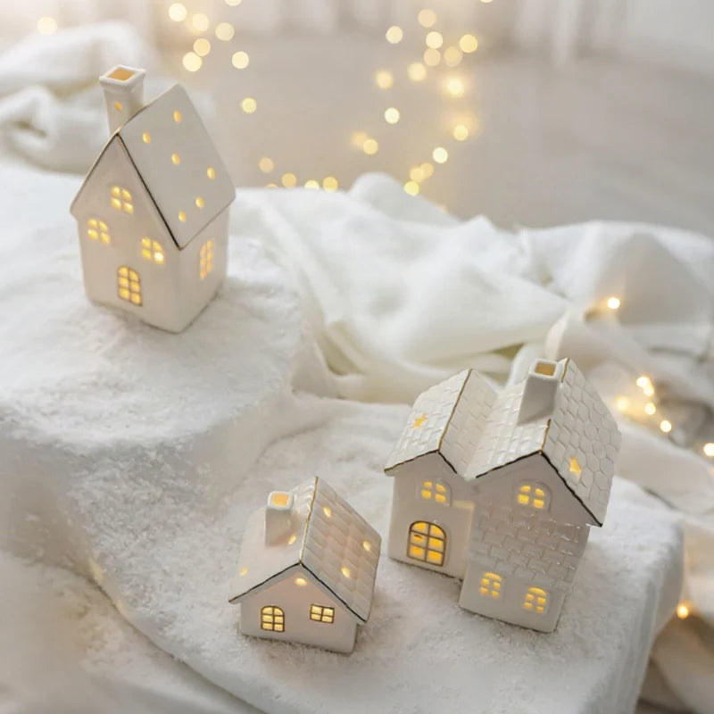 Illuminated ceramic village set with white houses, snowmen, and fir trees with warm glowing windows 8