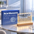 Illuminated periodic table display with 83 real element samples in crystal-clear acrylic with warm LED lighting and natu