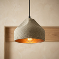 Stylish industrial cement pendant light with warm copper interior.