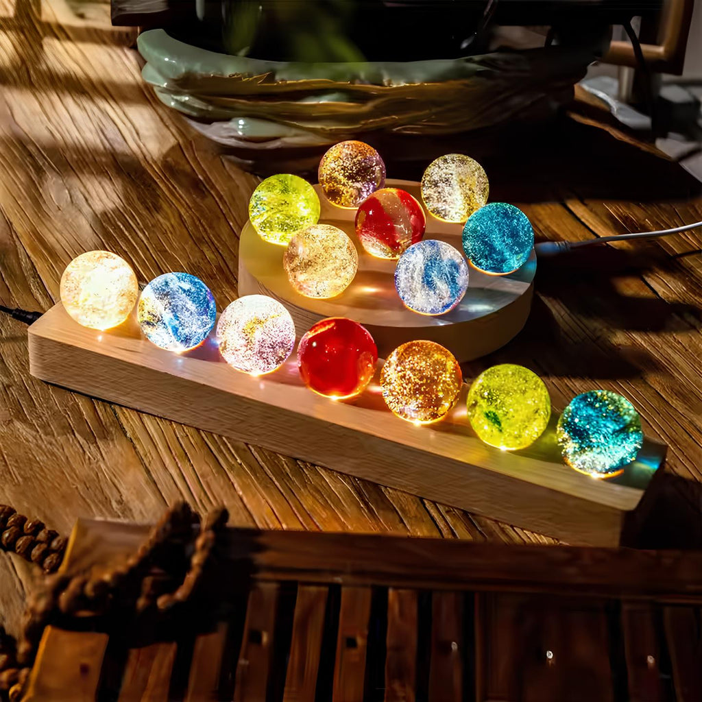 Set of seven luminous crystal galaxy orbs on wooden base with USB-powered LED lighting