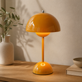 Stylish cordless table lamp with a rounded bud-like dome and touch control.