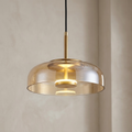 Elegant Nordic glass pendant light with a warm glow.