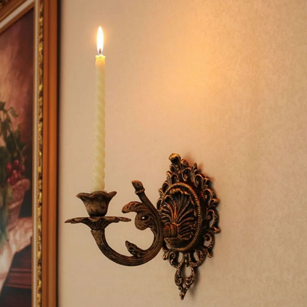 Ornate cast iron wall-mounted candle sconce with vintage scrollwork design