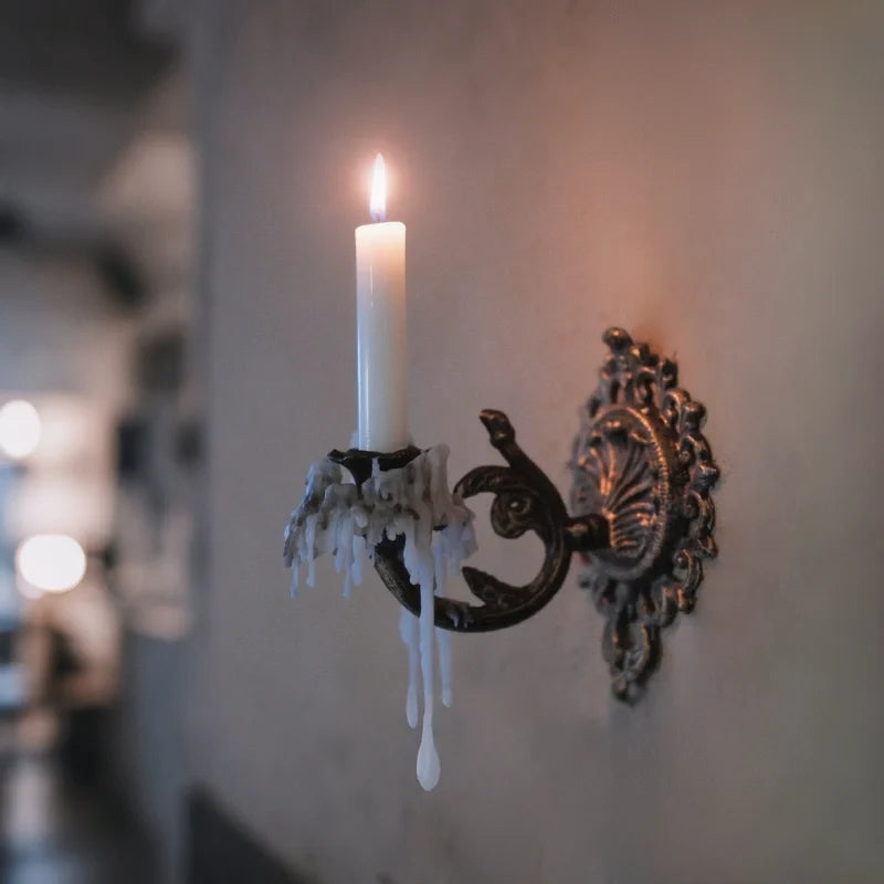 Ornate cast iron wall-mounted candle sconce with vintage scrollwork design 11