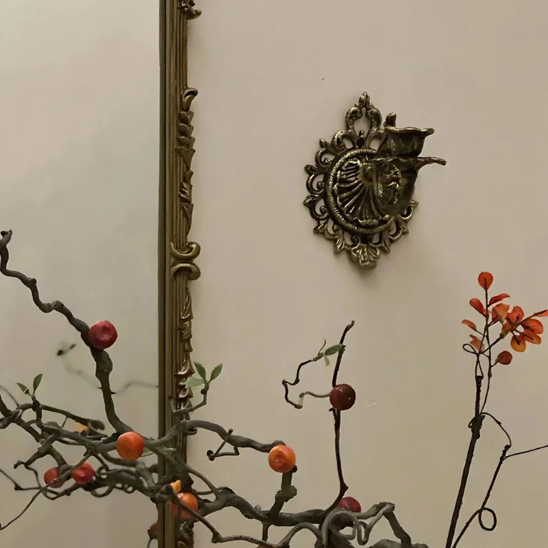 Ornate cast iron wall-mounted candle sconce with vintage scrollwork design 15