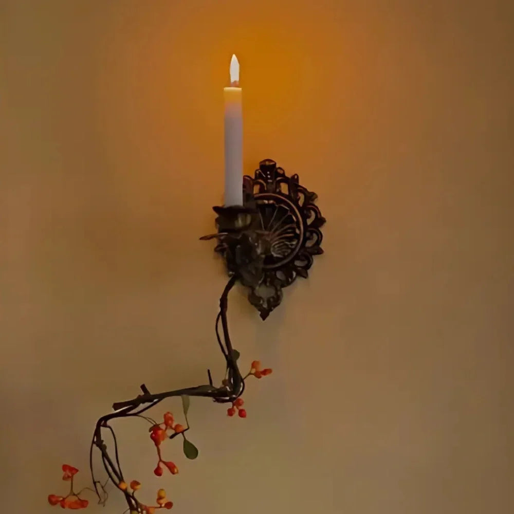 Ornate cast iron wall-mounted candle sconce with vintage scrollwork design 2