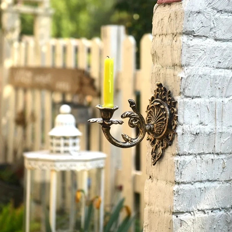 Ornate cast iron wall-mounted candle sconce with vintage scrollwork design 7
