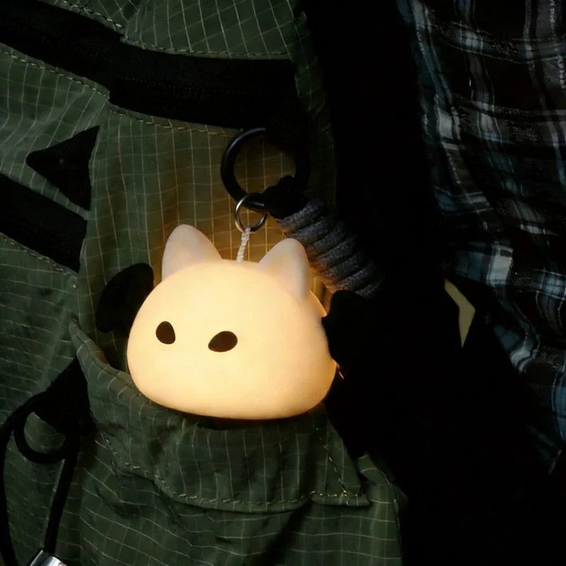 Compact touch-activated purse light illuminating a dark handbag interior. 12
