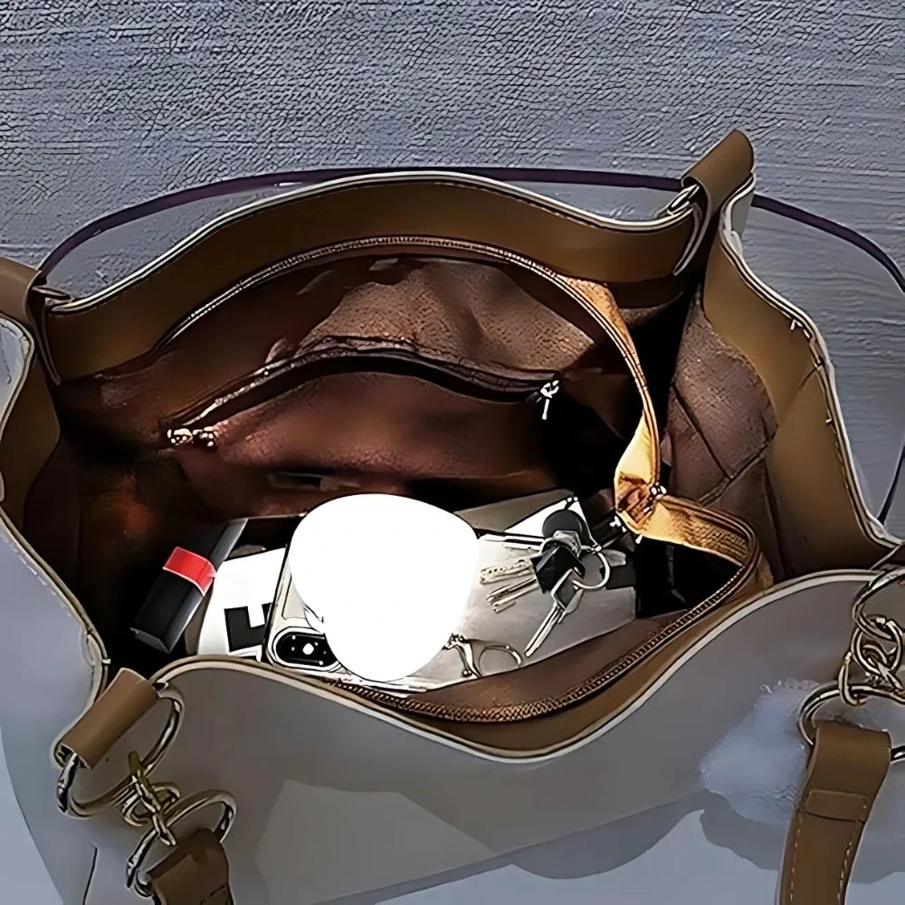 Compact touch-activated purse light illuminating a dark handbag interior. 3
