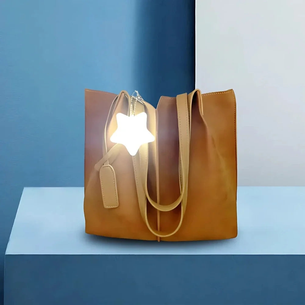 Compact touch-activated purse light illuminating a dark handbag interior. 8