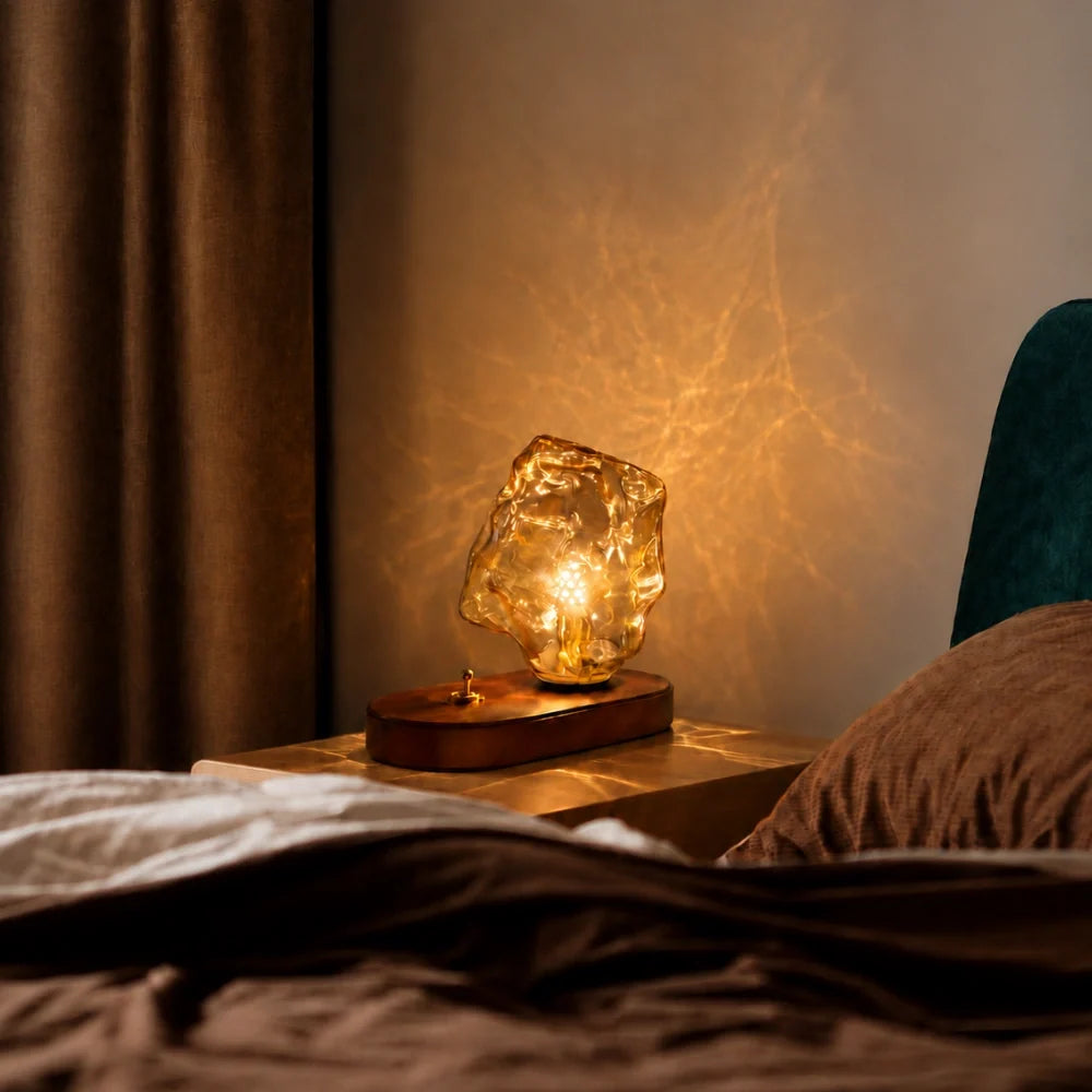 Sculptural amber glass table lamp with warm glow and natural oak base 3