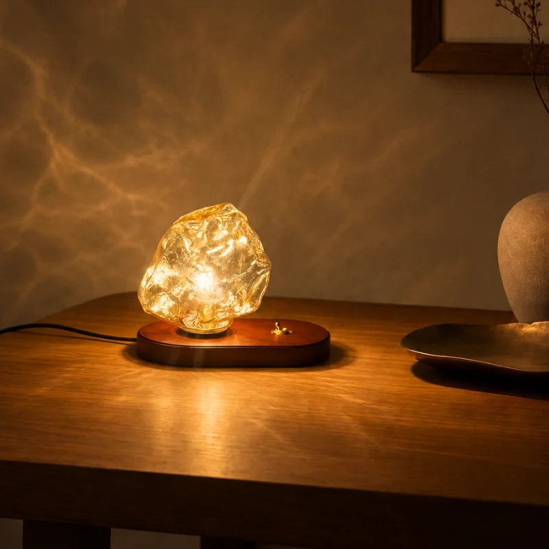 Sculptural amber glass table lamp with warm glow and natural oak base 6