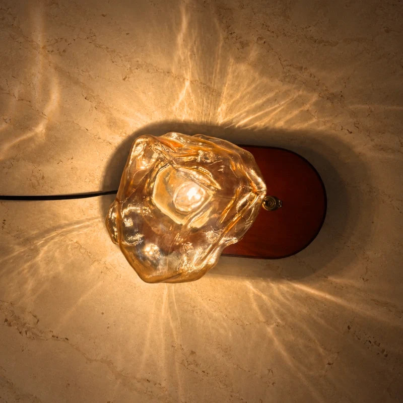 Sculptural amber glass table lamp with warm glow and natural oak base 7