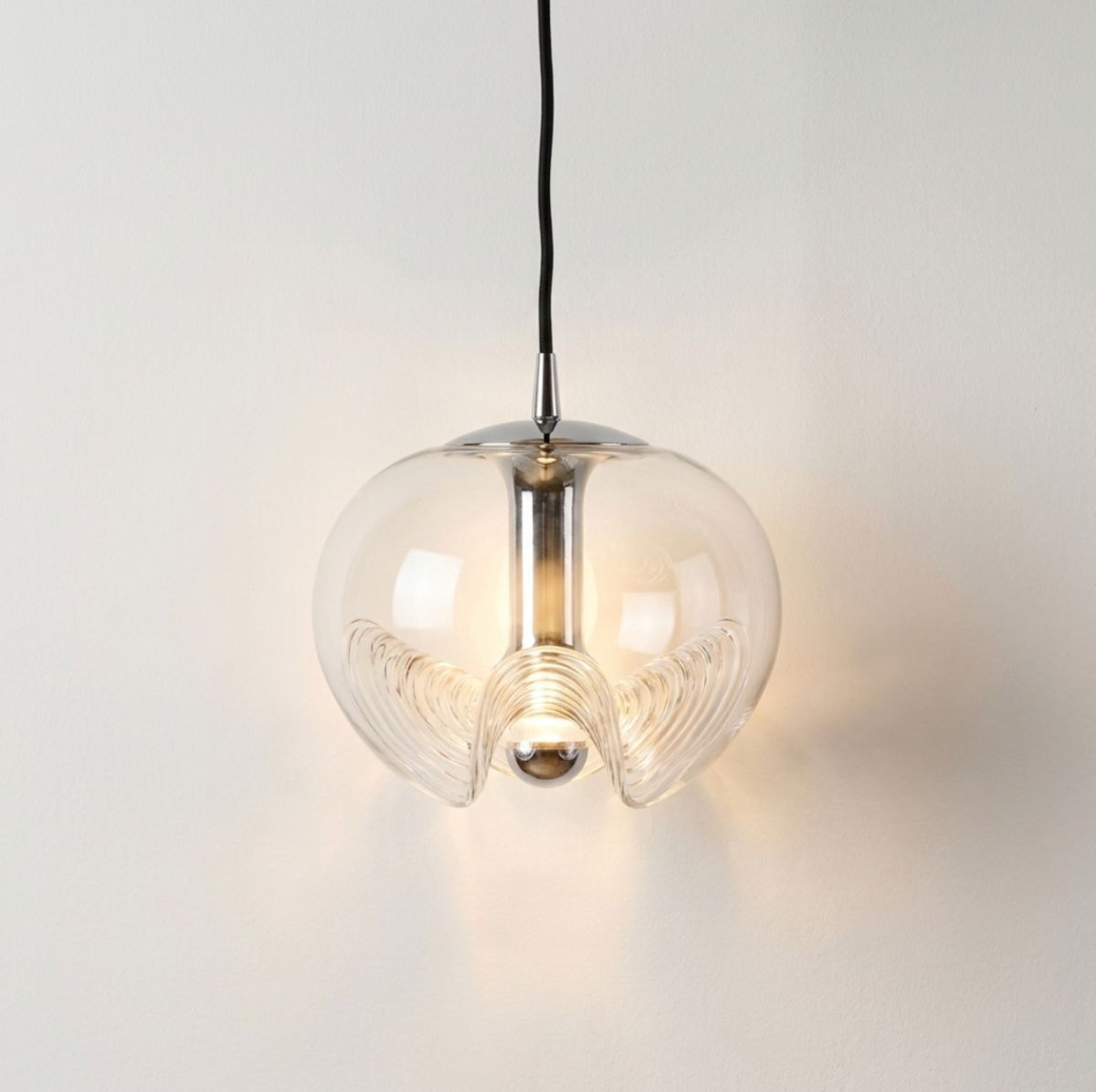 Sculptural glass globe pendant light hanging from the ceiling.