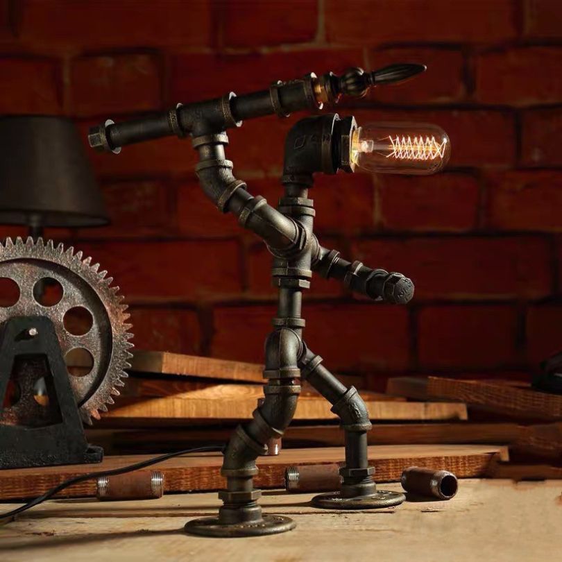 Sculptural Steampunk Sentinel Light crafted from iron pipes with exposed vintage bulb 11