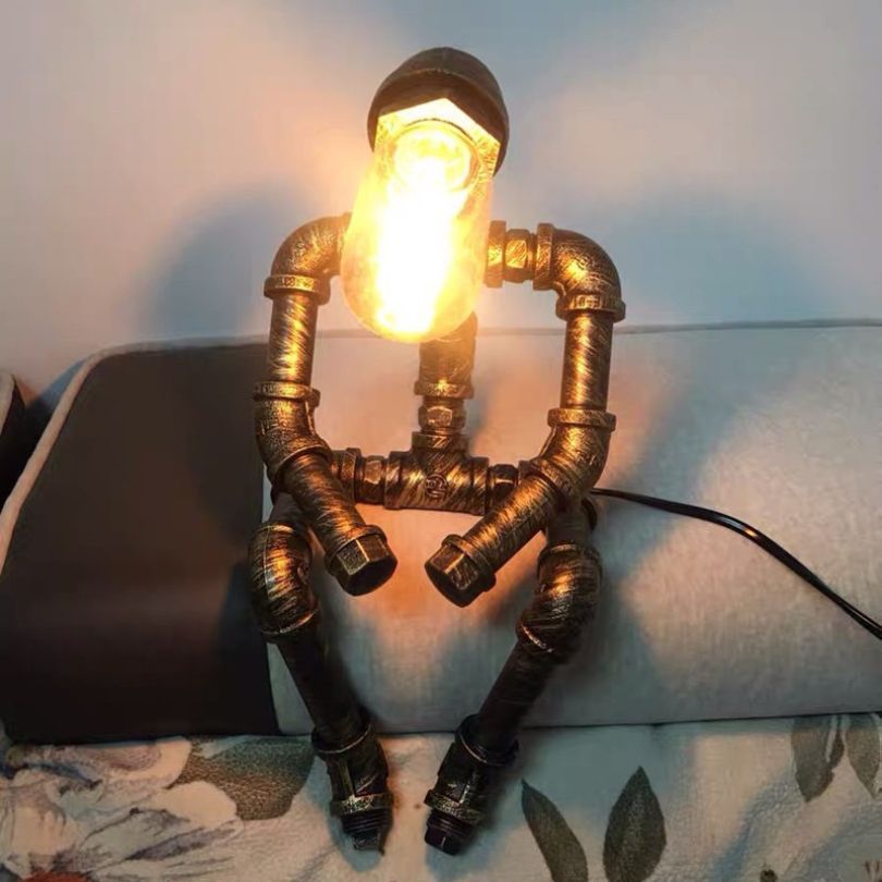 Sculptural Steampunk Sentinel Light crafted from iron pipes with exposed vintage bulb 13