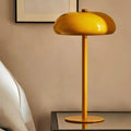 Sleek rechargeable retro table lamp with rounded top and touch control, emitting warm white light