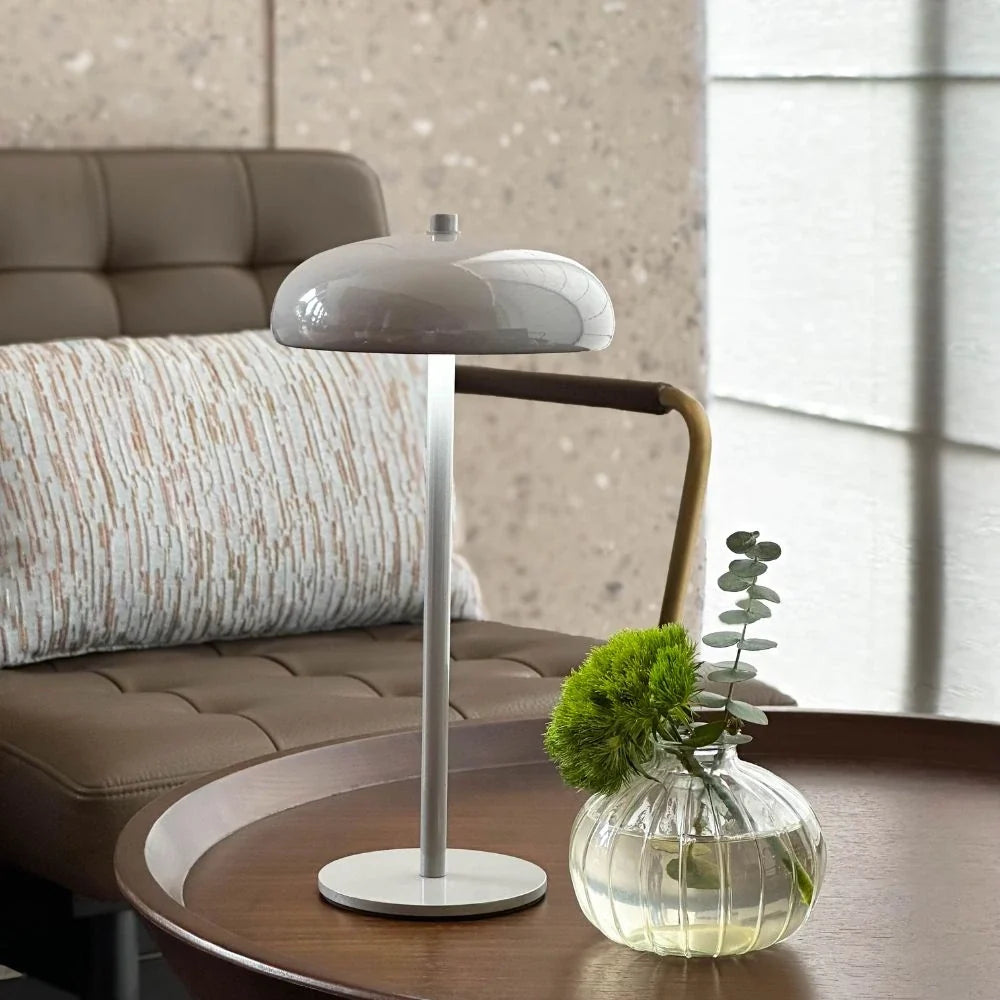 Sleek rechargeable retro table lamp with rounded top and touch control, emitting warm white light 10