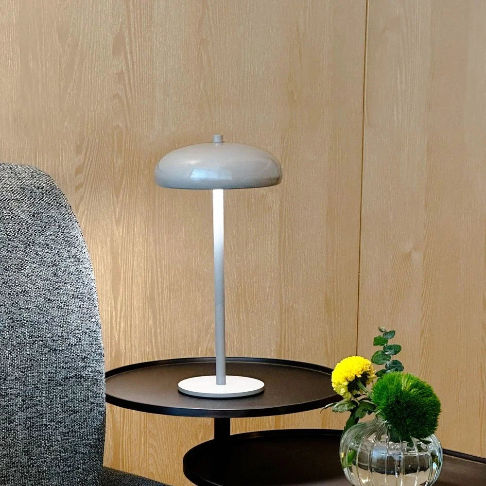 Sleek rechargeable retro table lamp with rounded top and touch control, emitting warm white light 12