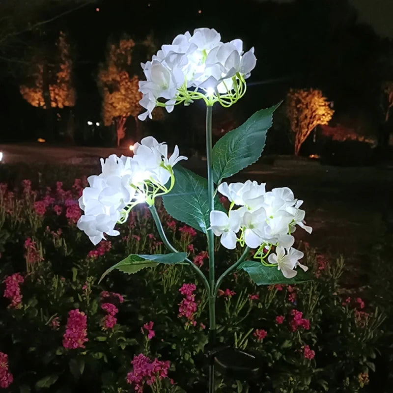 Solar flower lights with realistic blooms in warm and cool white colors for garden decoration 19