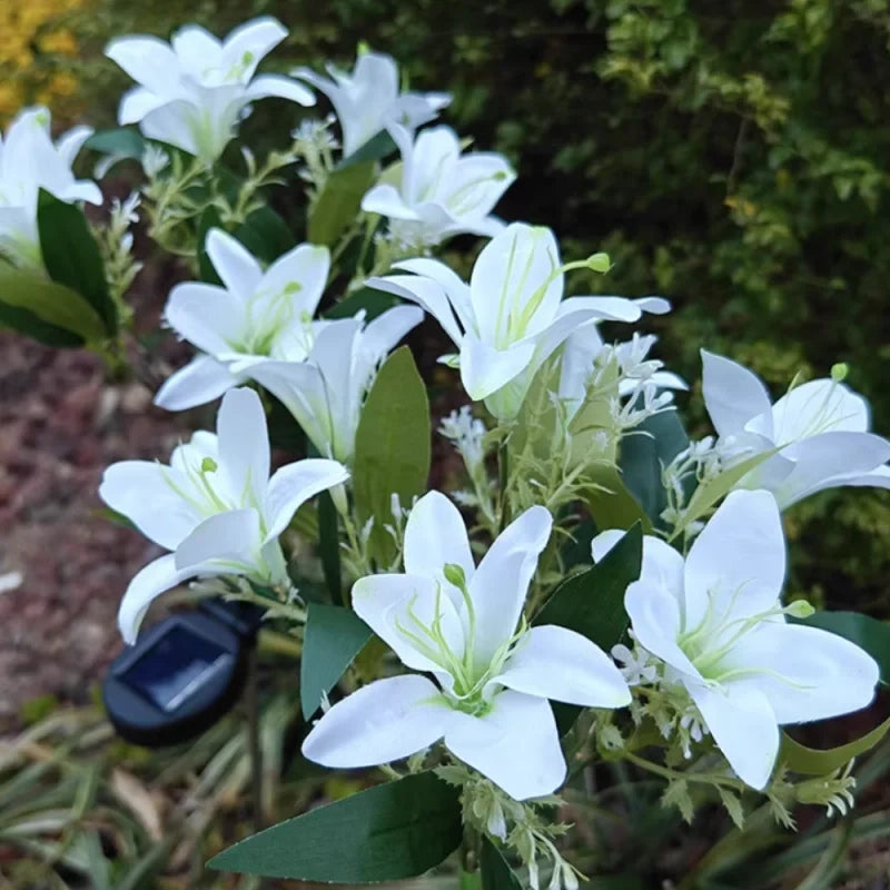 Solar flower lights with realistic blooms in warm and cool white colors for garden decoration 25