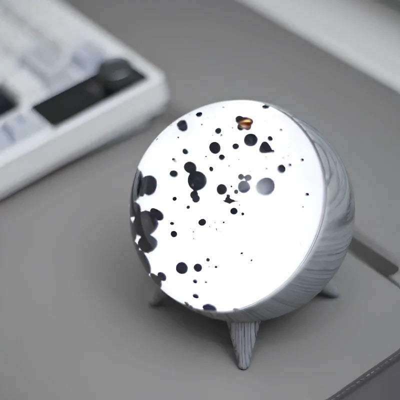 Sound-reactive ferrofluid display in clear glass sphere with black liquid pulsing to music rhythm 10