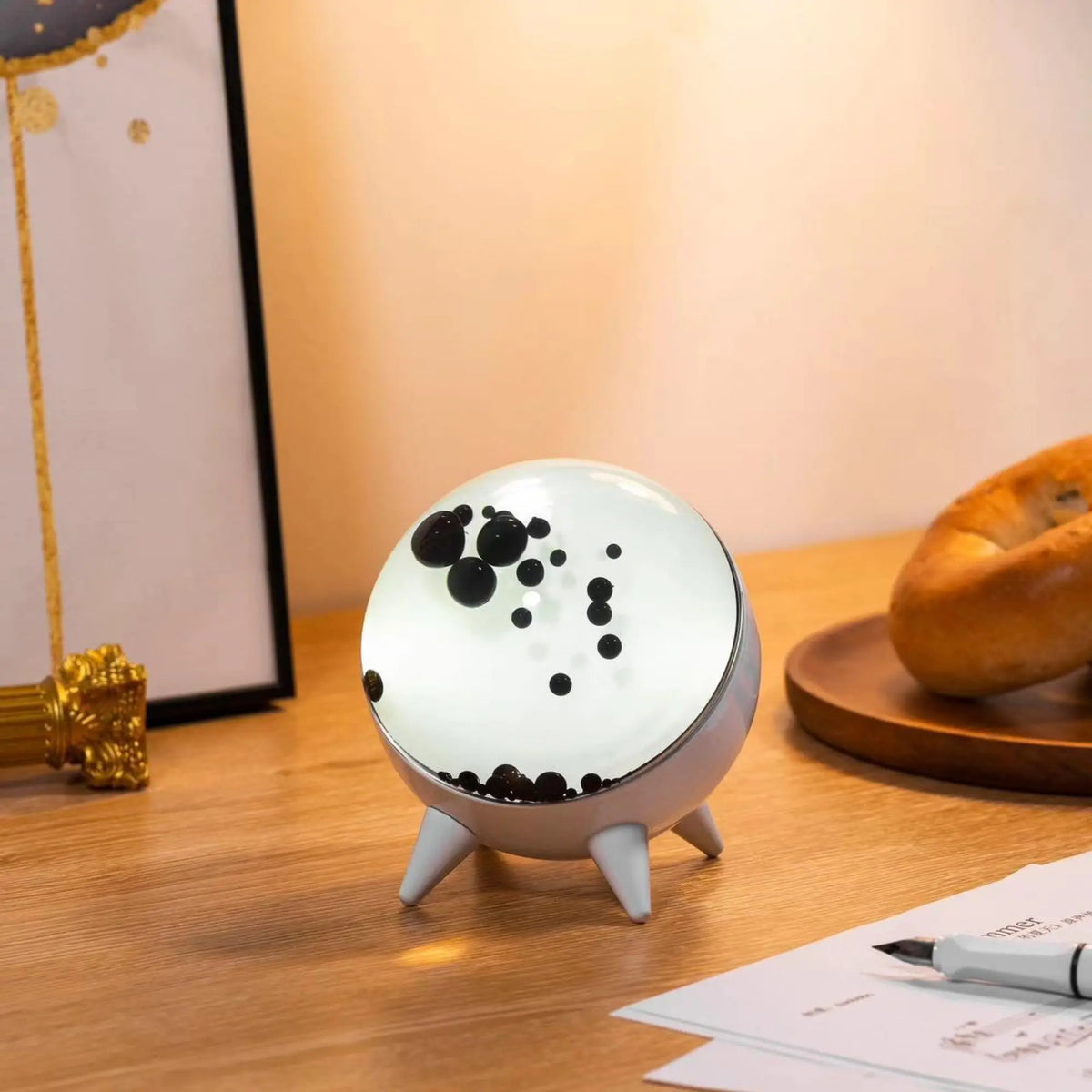 Sound-reactive ferrofluid display in clear glass sphere with black liquid pulsing to music rhythm 2